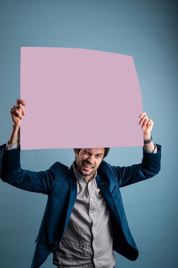 Happy smiling man showing blank signboard with empty copyspace area for slogan or advertising text message stock image