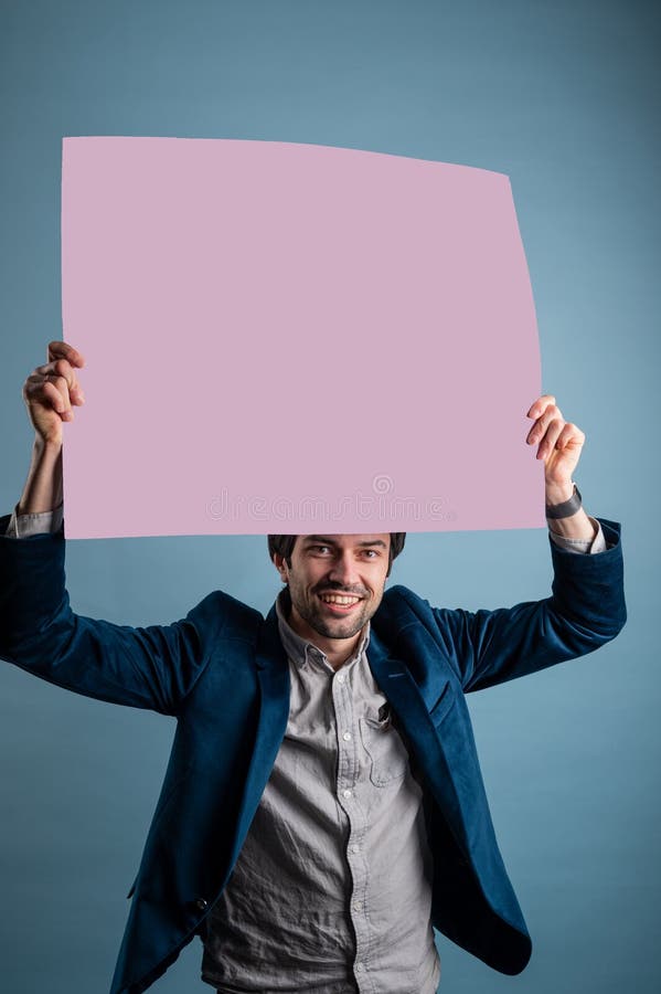 Happy smiling man showing blank signboard with empty copyspace area for slogan or advertising text message stock photos