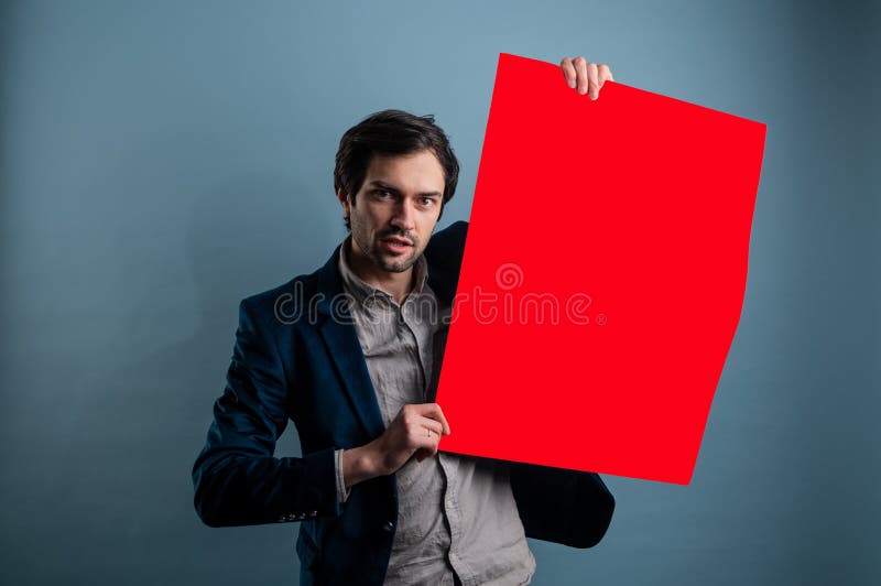 Happy smiling man showing blank signboard with empty copyspace area for slogan or advertising text message stock image
