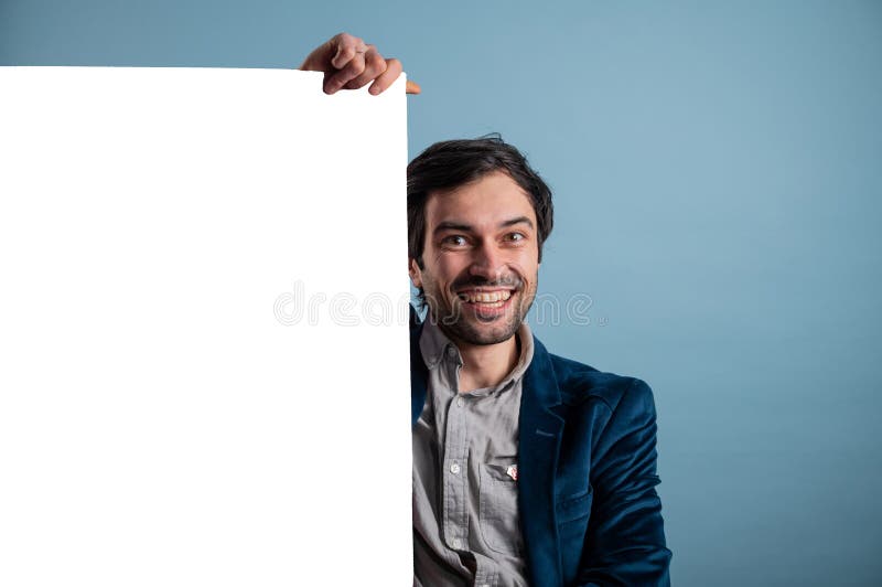 Happy smiling man showing blank signboard with empty copyspace area for slogan or advertising text message stock photo