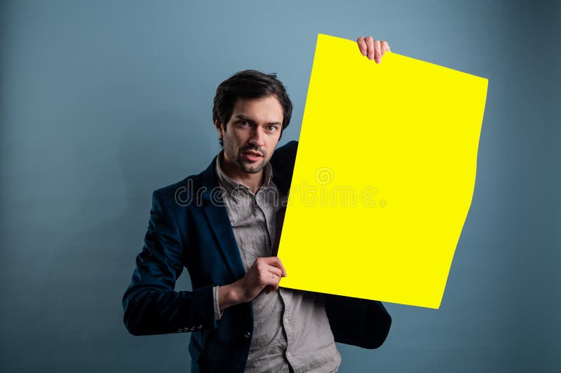 Happy smiling man showing blank signboard with empty copyspace area for slogan or advertising text message royalty free stock image