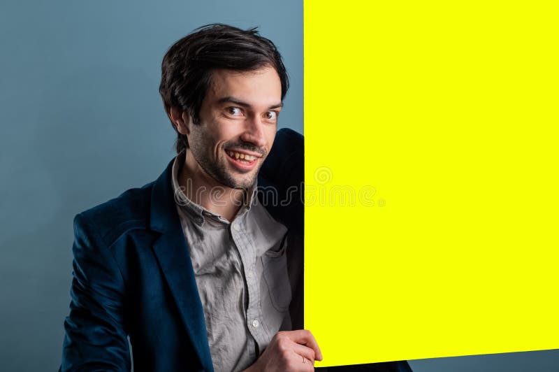 Happy smiling man showing blank signboard with empty copyspace area for slogan or advertising text message stock photos