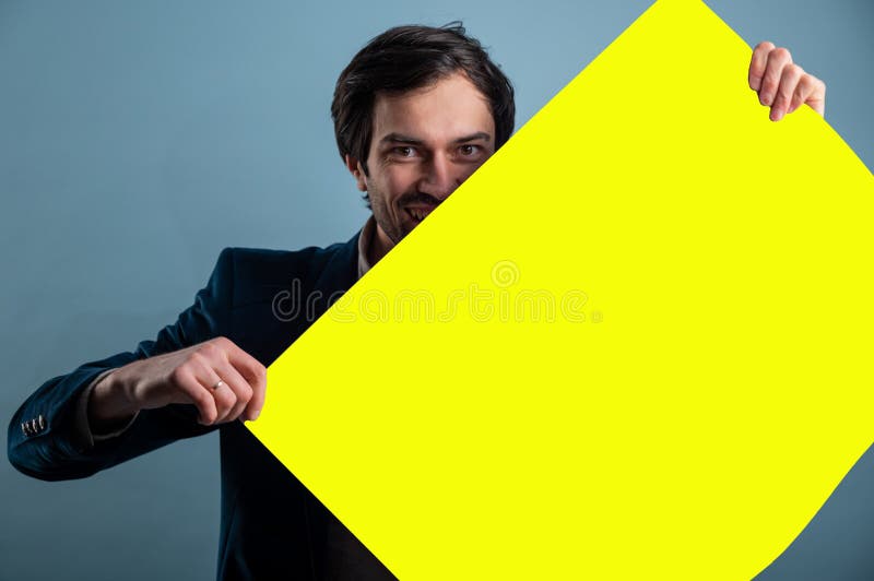 Happy smiling man showing blank signboard with empty copyspace area for slogan or advertising text message stock photography