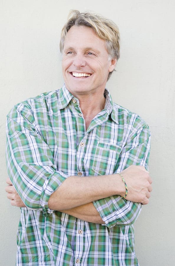 Happy smiling mature man in forties with blond hair and blue eyes. Happy smiling mature man in forties with blond hair and blue eyes.