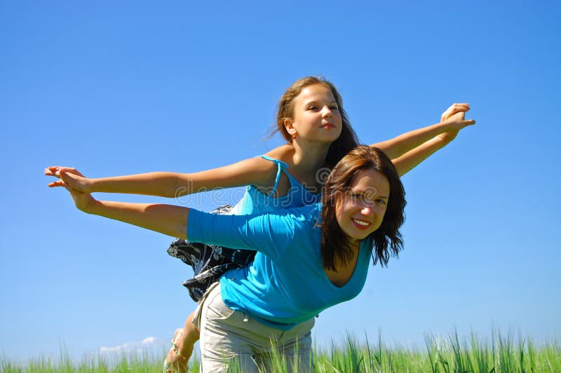 Happy smiling Mother and the daughter fly in sky