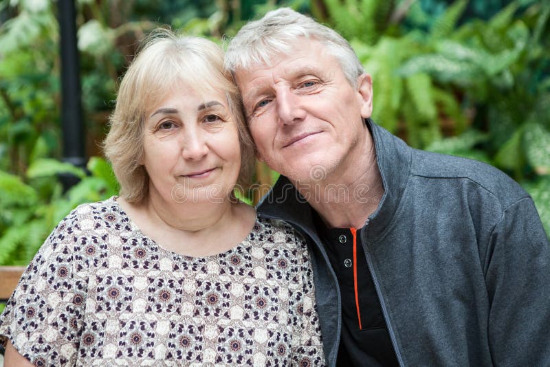 Happy and smiling senior couple portrait, sitting cheek to cheek together stock photography Happy and smiling senior couple portrait, sitting cheek to cheek together stock photography