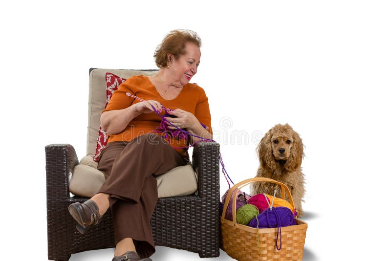 Happy smiling senior woman knitting with her dog stock photos Happy smiling senior woman knitting with her dog stock photos