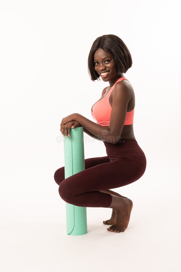 Happy Smiling Slim African Girl Crouched and Leaned on Blue Yoga