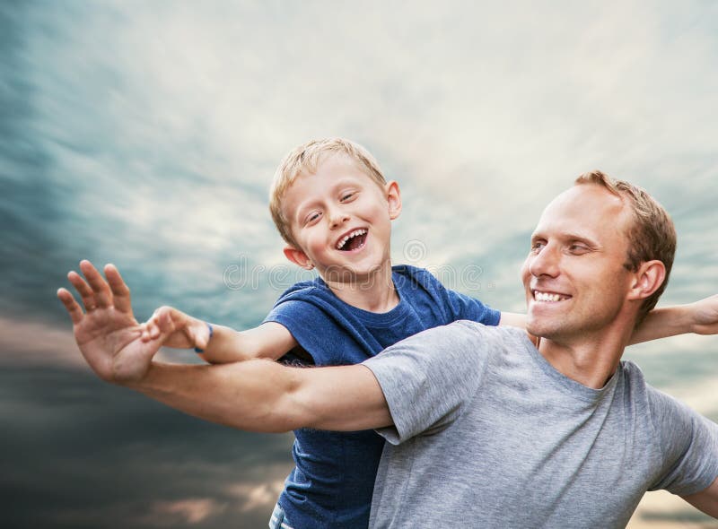 Happy smiling son and father portrait over blue sky