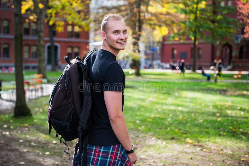 Happy smiling student man with backpack going to study in university campus stock photos Happy smiling student man with backpack going to study in university campus stock photos