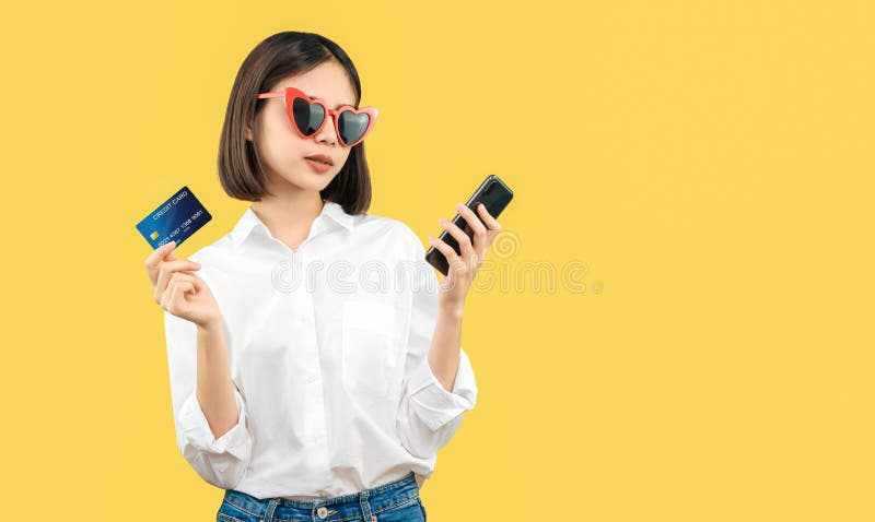 Happy smiling woman holding smart phone and credit card with shopping online. royalty free stock image Happy smiling woman holding smart phone and credit card with shopping online. royalty free stock image