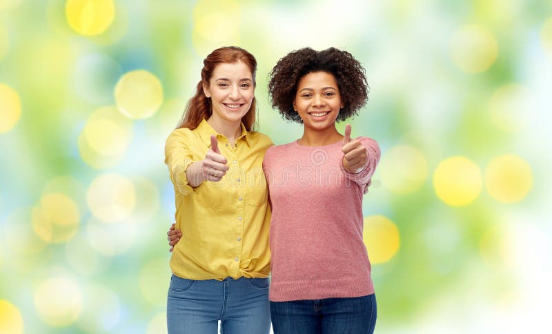 Happy smiling women showing thumbs up