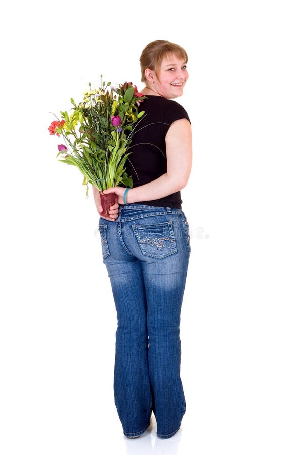 Happy smiling young girl presenting flowers