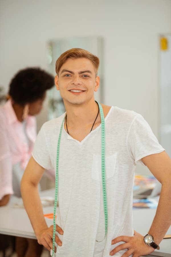Happy smiling young man with a measuring tape stock images Happy smiling young man with a measuring tape stock images