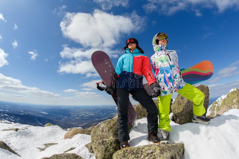 Happy snowboarding couple in winter mountains stock photography.