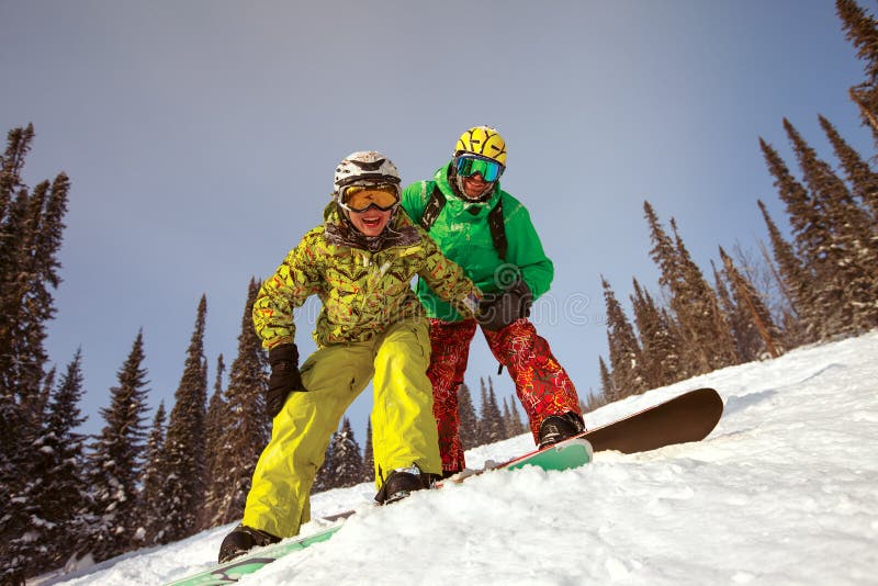 Happy snowboarding couple stock image