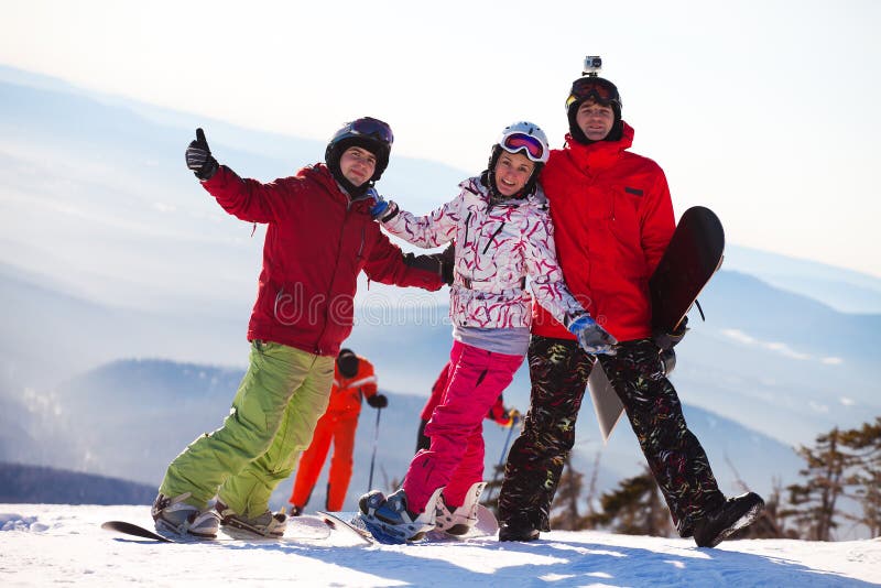 Happy snowboarding team stock image