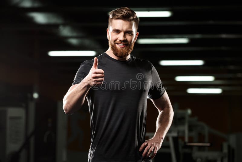 Happy sports man showing thumbs up gesture.