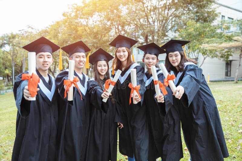 Happy Students in Graduation Gowns Holding Diplomas on University ...