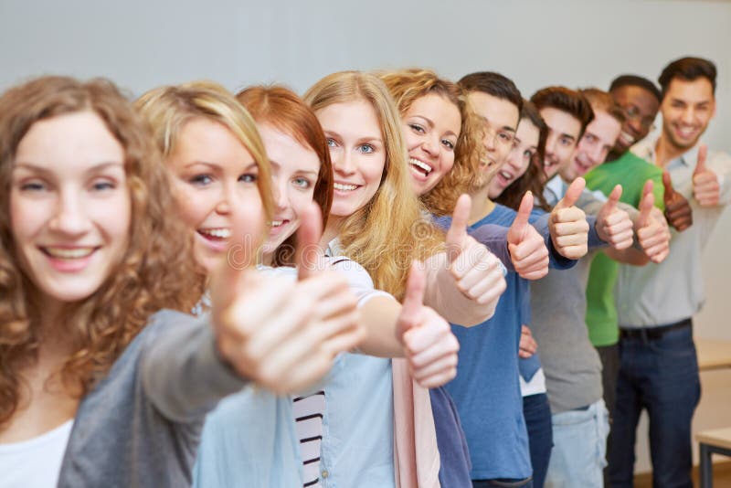 Happy students holding thumbs up stock photos