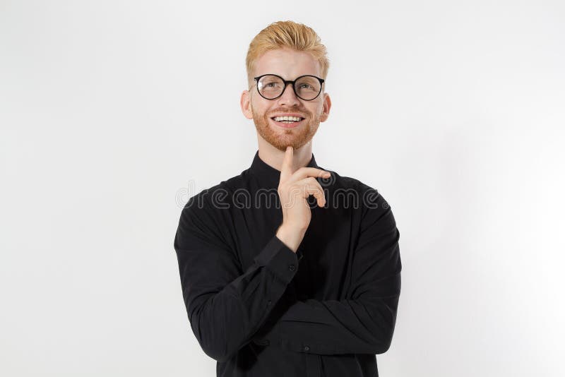 Happy Stylish guy in black shirt and glasses. Folded arms, copy space. Successful young, Entrepreneur concept. Redheaded man