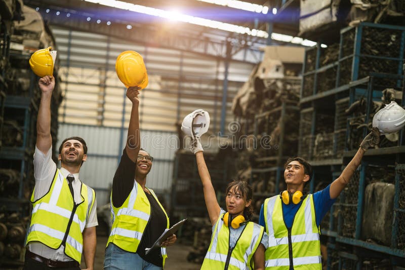 Happy success job done grateful engineer employee team staff worker group together in old grunge garage used auto part warehouse stock images