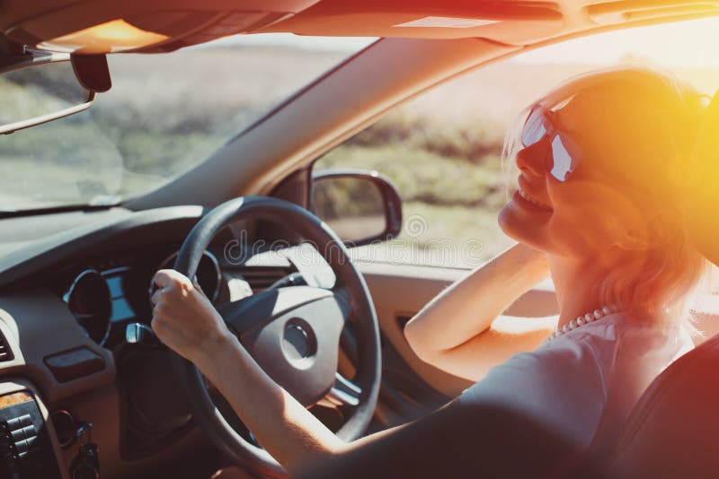 Happy successful adult woman enjoys driving in a road adventure. Holiday vacation travel concept royalty free stock photo Happy successful adult woman enjoys driving in a road adventure. Holiday vacation travel concept royalty free stock photo