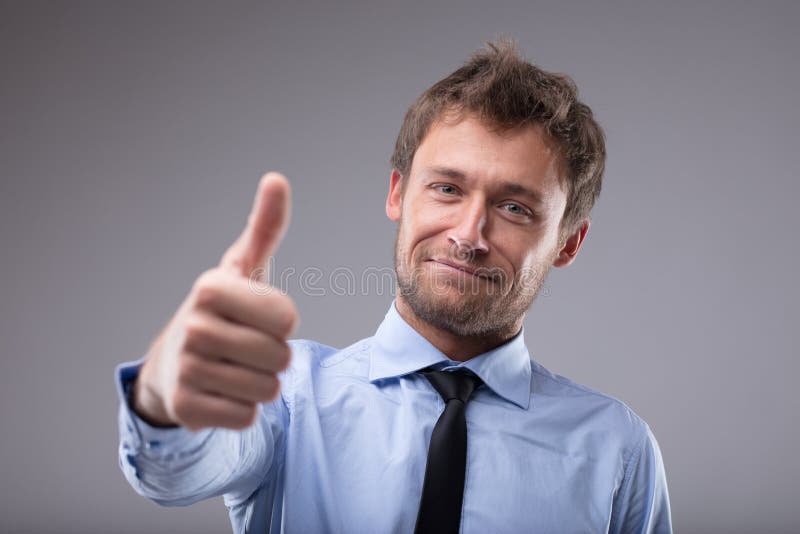 Happy successful man giving a thumbs up gesture royalty free stock photos