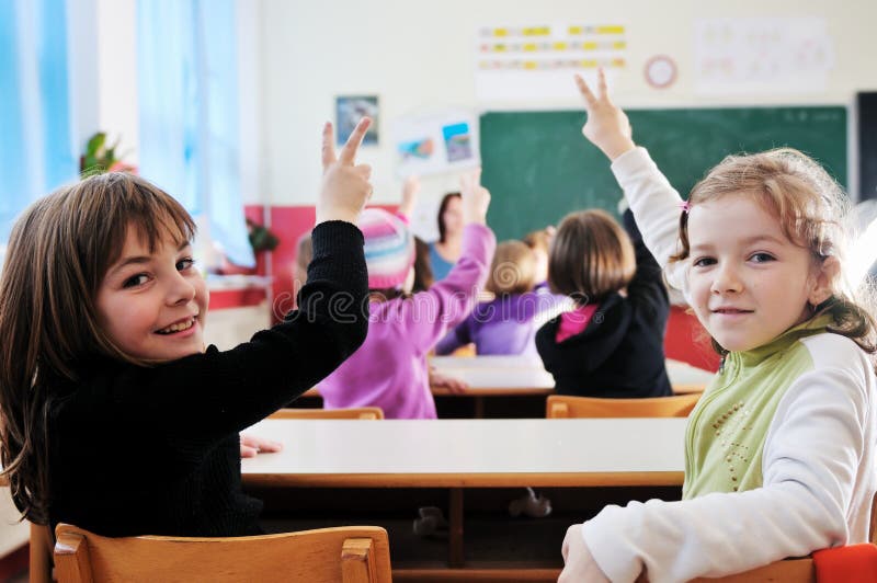 Happy teacher in school classroom