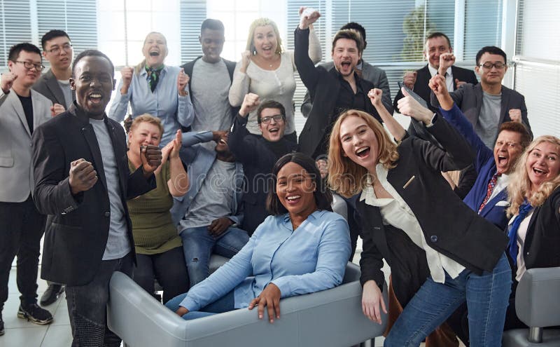 happy team of diverse corporate employees in the office lobby.