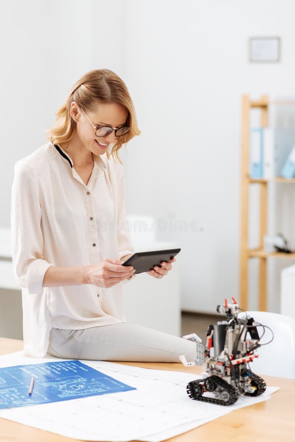 Happy Technology Specialist Working with Robot in the Laboratory Stock