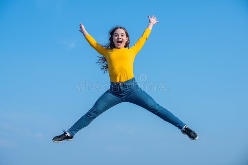 happy teen girl jump high on sky background. happiness