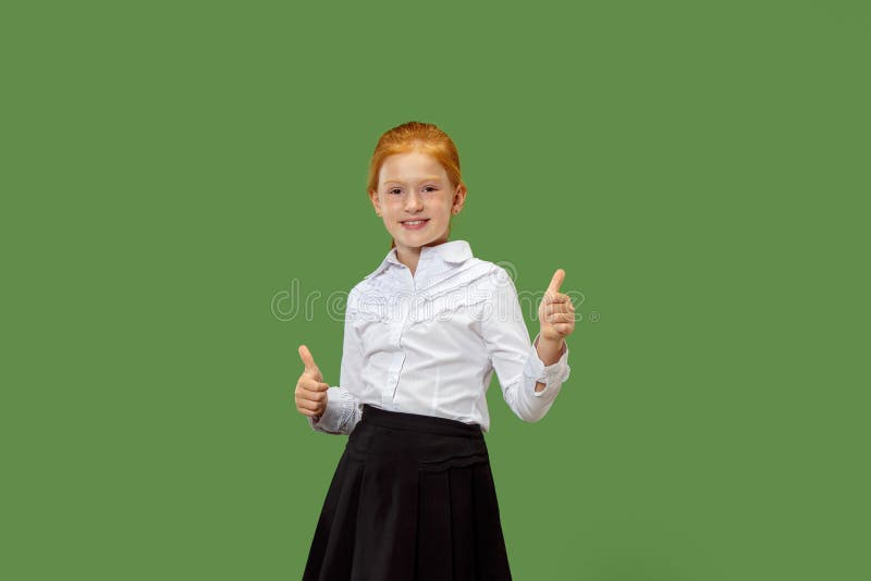 The happy teen girl standing and smiling against p green background. stock photos The happy teen girl standing and smiling against p green background. stock photos