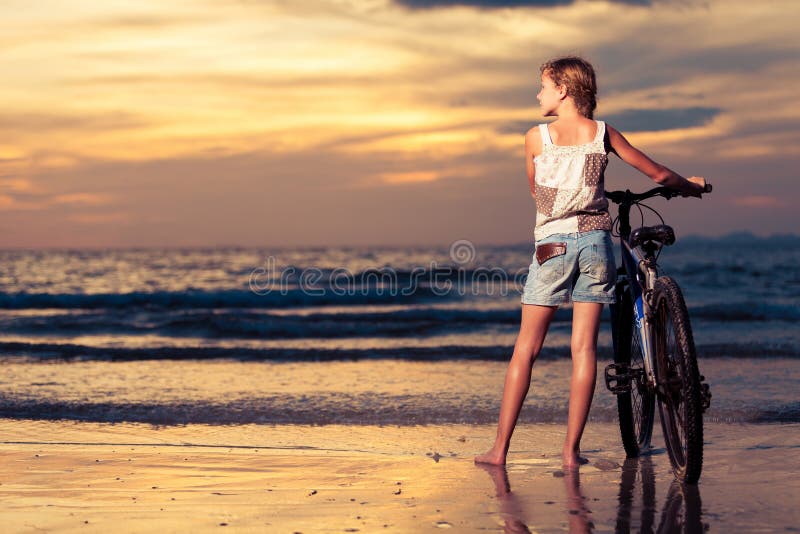 Healthy Teen Girl Walking With A Bike In Summer Stock