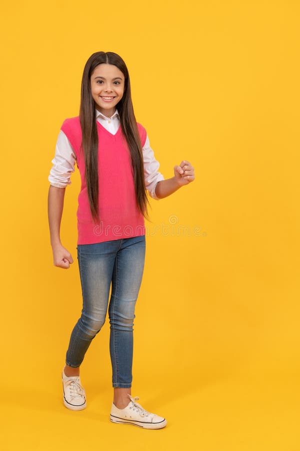 Happy Teen School Girl Walking on Yellow Background, Copy Space ...