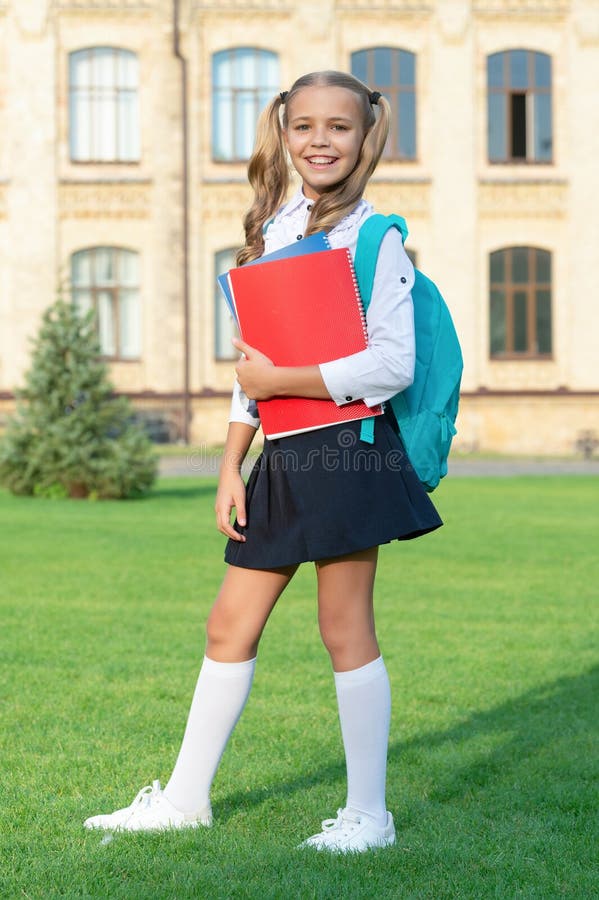 Happy Teenage Girl in School Uniform Standing in Front of School. Back ...