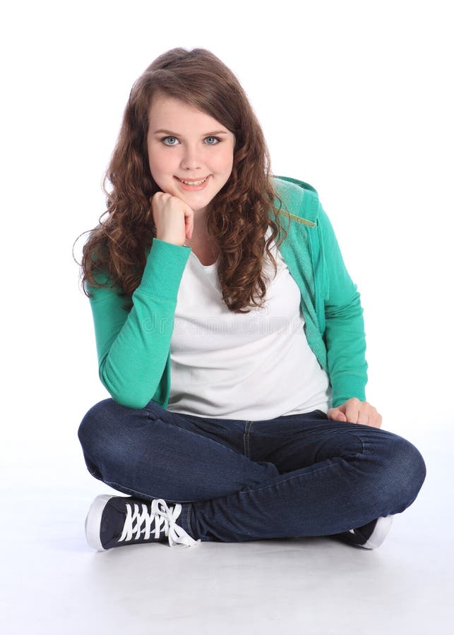 Happy teenage student girl sitting cross legged