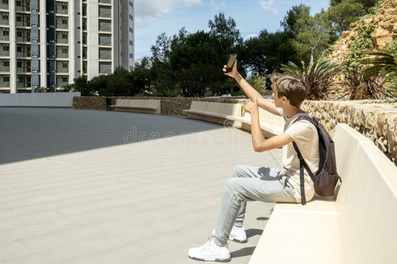 Teen boy distracting from online lesson and playing video games, scrolling  phone. Learning difficulties, online education, entertainment at home Stock  Photo - Alamy