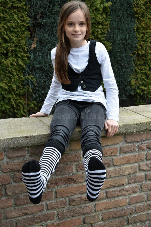 https://thumbs.dreamstime.com/b/happy-teeny-striped-socks-teenage-girl-black-white-sitting-wall-garden-264466820.jpg