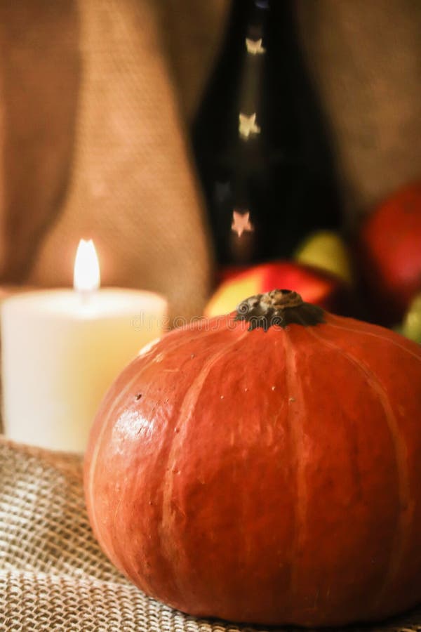 Happy Thanksgiving post card. Autumn holidays still life. Halloween orange pumpkin with soft candle light on sackcloth royalty free stock photos Happy Thanksgiving post card. Autumn holidays still life. Halloween orange pumpkin with soft candle light on sackcloth royalty free stock photos