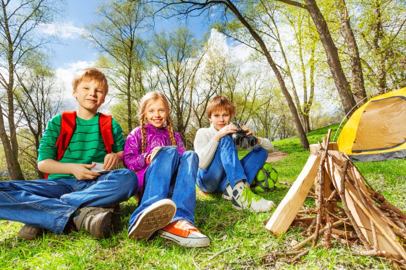 Happy three friends rest together during camping royalty free stock image Happy three friends rest together during camping royalty free stock image