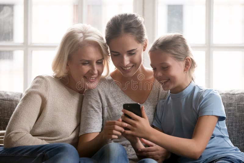 Happy three generations looking at mobile screen. royalty free stock images Happy three generations looking at mobile screen. royalty free stock images