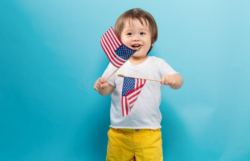 Happy toddler boy waving American flags royalty free stock photos Happy toddler boy waving American flags royalty free stock photos