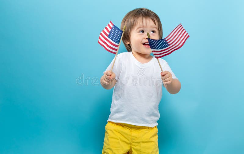 Happy toddler boy waving American flags royalty free stock photo Happy toddler boy waving American flags royalty free stock photo