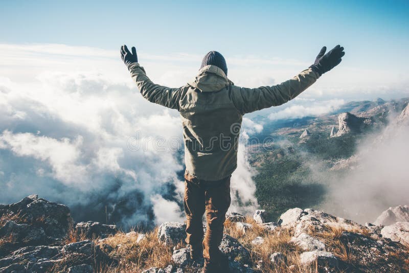 Happy Traveler on mountain summit hands raised. Over clouds Travel Lifestyle success concept adventure active vacations outdoor royalty free stock photography Happy Traveler on mountain summit hands raised. Over clouds Travel Lifestyle success concept adventure active vacations outdoor royalty free stock photography