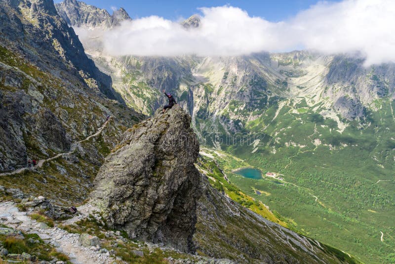 Happy trekking girl on the rock at High Tatras mountains, Slovak