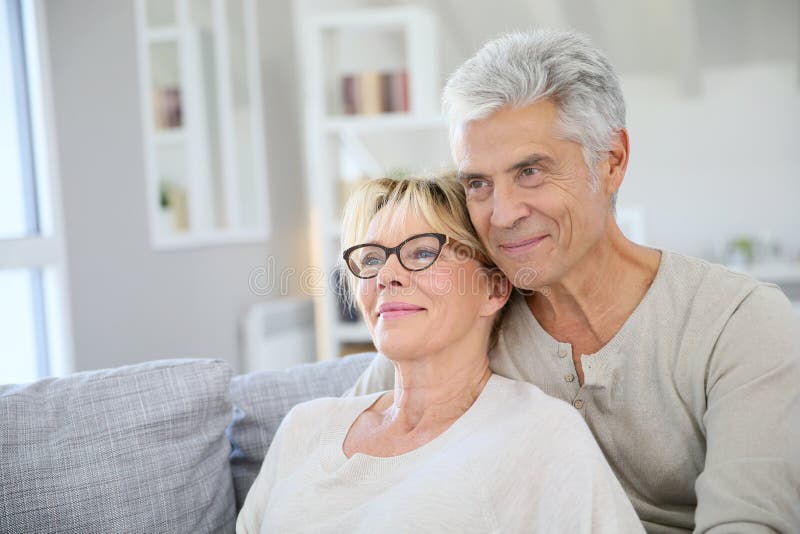 Happy trendy senior couple at their new home