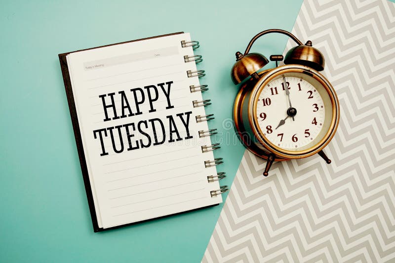 Happy Tuesday Text and Alarm Clock on Blue Background Stock Photo