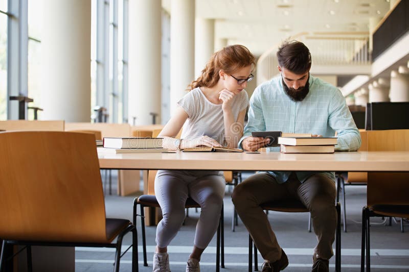 Happy University Students Studying With Books In Library Group Of