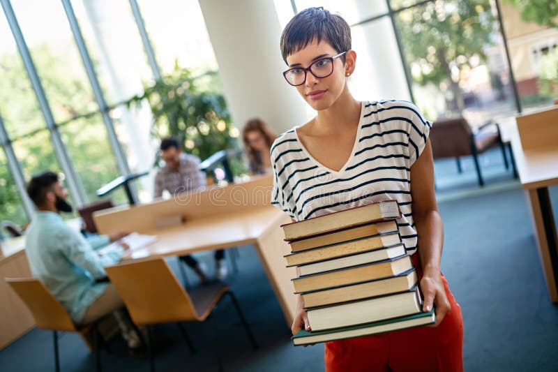 Happy University Students Studying With Books In Library Group Of